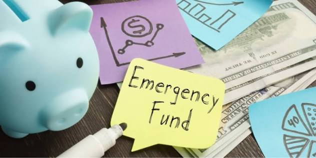 Emergency Fund savings plan with budgeting notebook, calculator, and money management essentials.